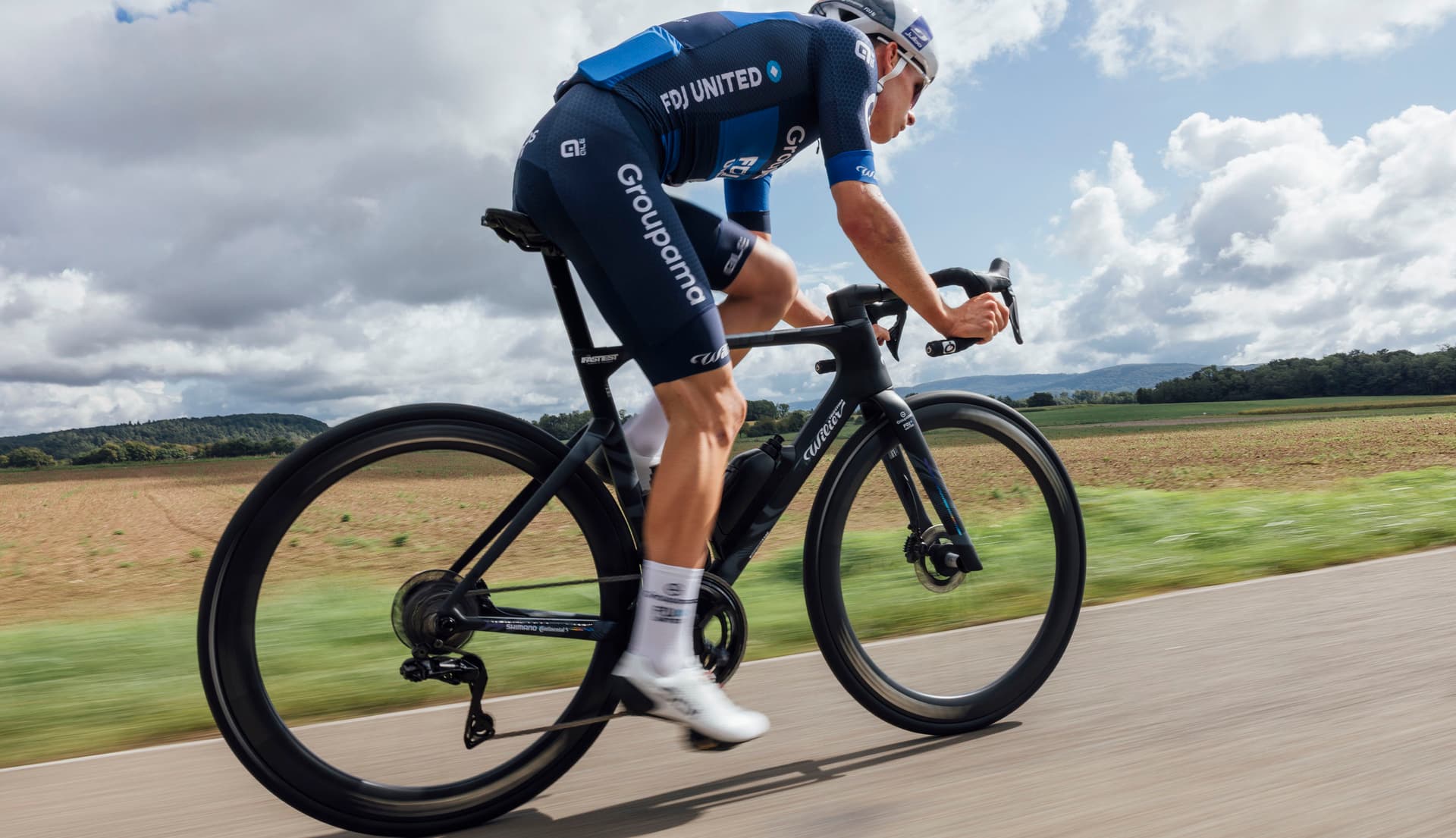 Cyclist riding a road bike on an Italian alpine mountain road — Wilier lifestyle hero